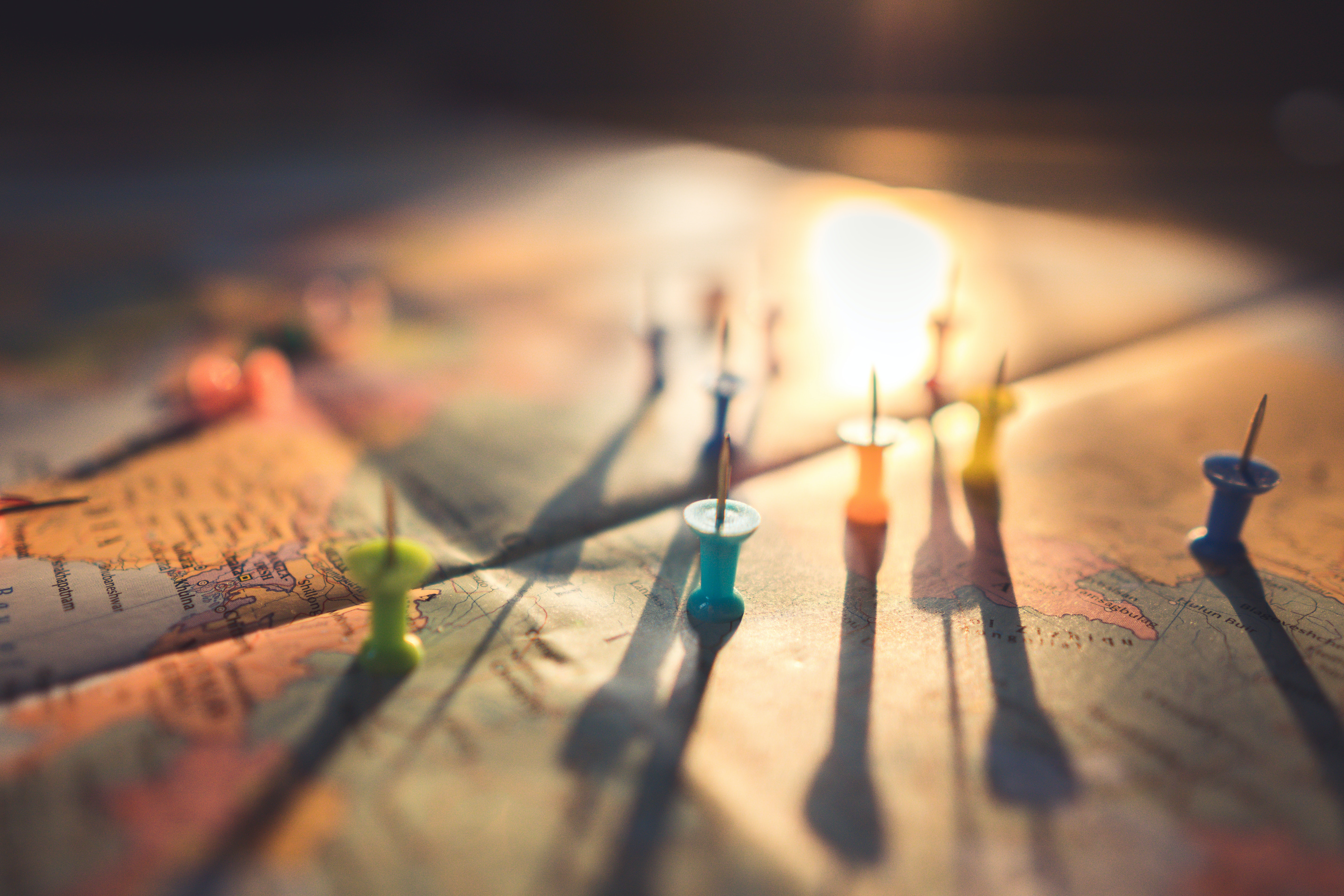 World Map with Push Pins Arranged Across Its Surface